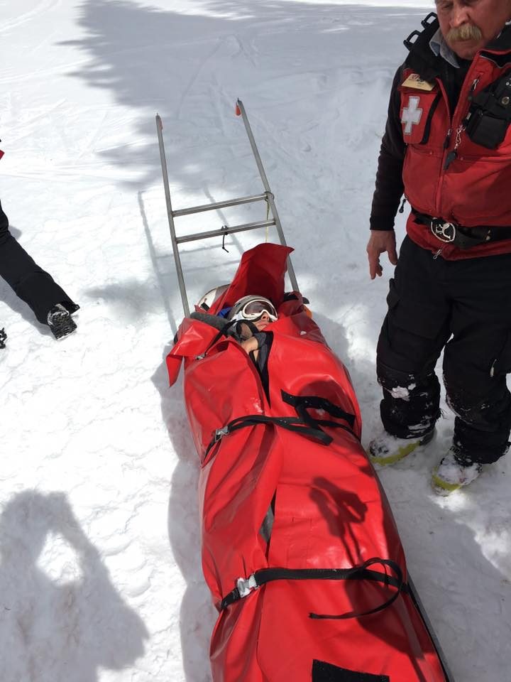 Anthony being rescued on a sled after his skiing accident